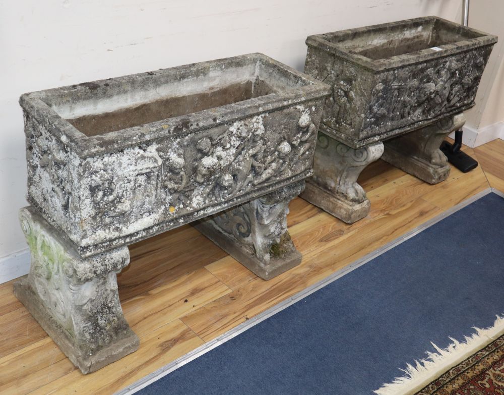 A near pair of reconstituted stone garden planters, on lions paw and scroll moulded supports, W.87cm, D.34cm, H.70cm